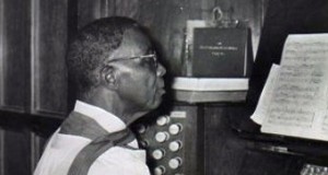 Ekundayo Phillips playing the organ