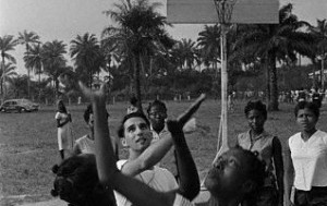 American culture of basketball enters Nigeria through a chemistry teacher at Queens college in Lagos, who here plays basketball with her students of the college, a secondary school for girls. Rosenberg introduced the sport to the country. 