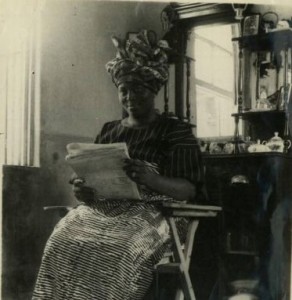 African Woman reads her morning papers in early 1930s