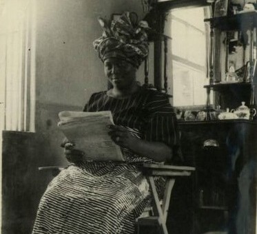 African Woman reads her morning papers in early 1930s