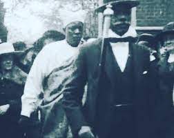 Ahmodu Tijani led by his staff bearer, Herbert Macualay at a London event in 1921