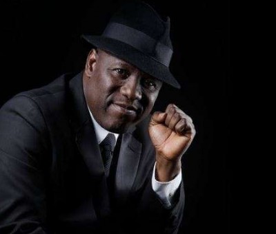 Kenny Ogungbe in dark hat