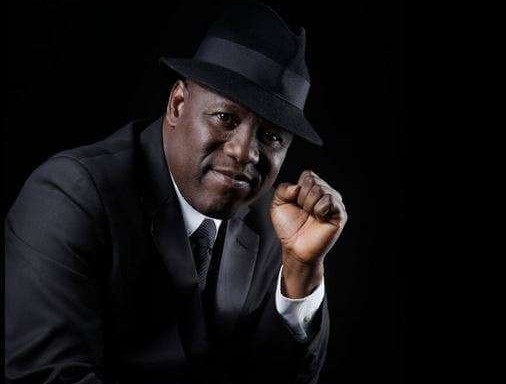 Kenny Ogungbe in dark hat