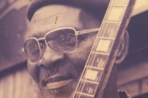 Fatai Olayiwola Olagunju with his guitar